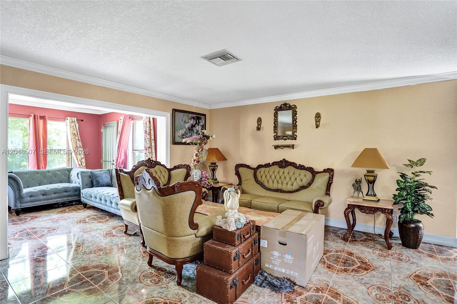 A living room features ornate vintage furniture, tiled floors, and a view into an adjacent room — 10688 Sleepy Brook Way, Boca Raton FL 33428, BOCA RATON, FL