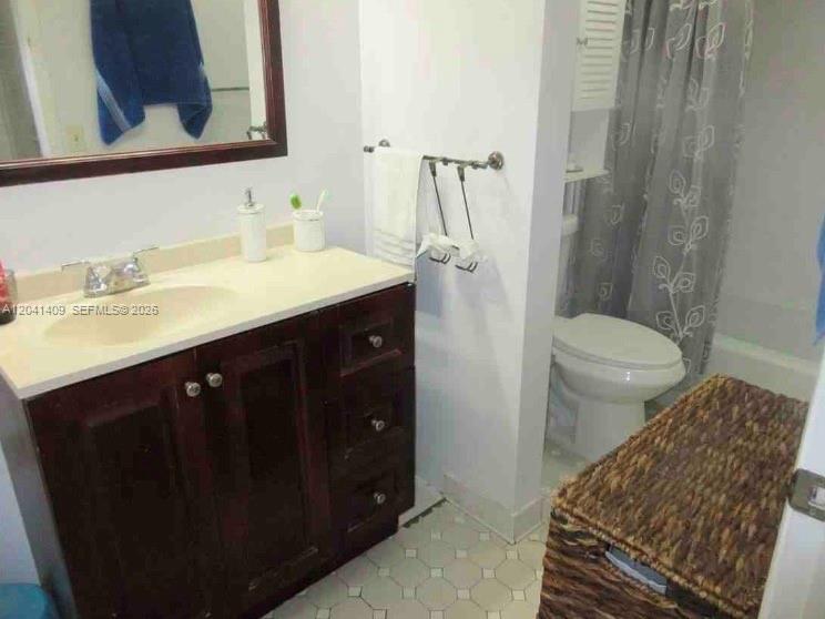 A bathroom features a dark wood vanity, a white countertop, a toilet, and a shower — 3601 SW 117th Ave # 301, Miami FL 33175, MIAMI, FL