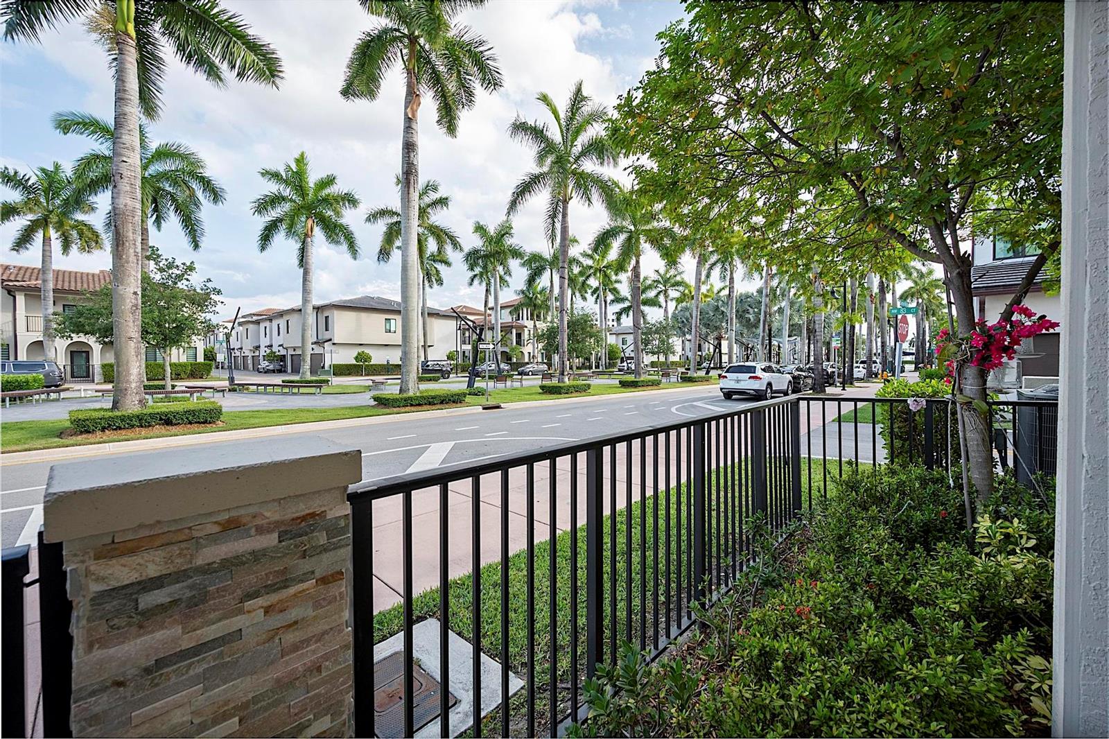 A view from a patio looking out at a street lined with palm trees — 8321 Central Park Boulevard, Doral FL 33166, DORAL, FL