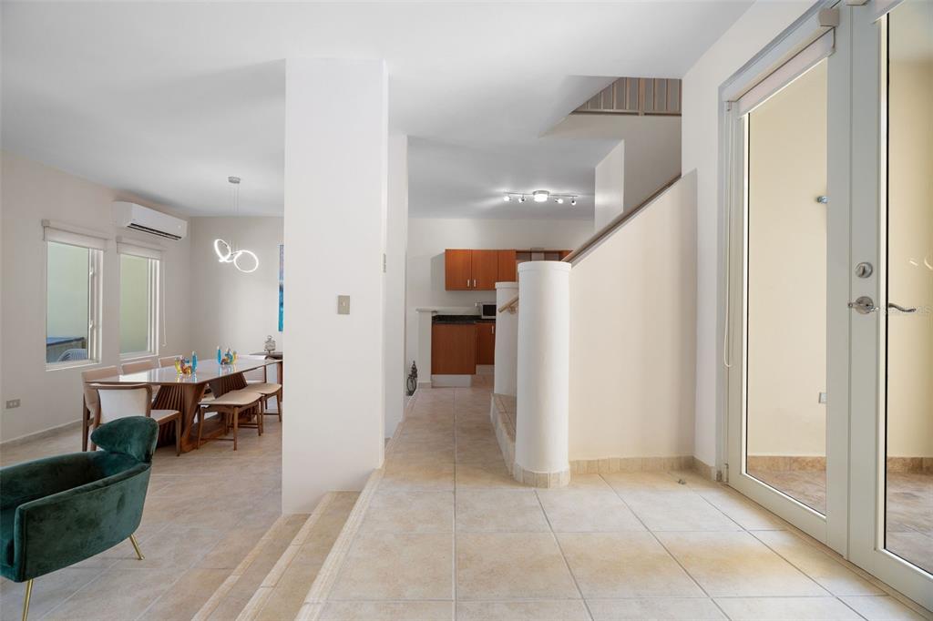 A tiled entryway leads to a dining area and a kitchen with wooden cabinets — 90 CANDELERO DRIVE UNIT 78, HUMACAO, PR