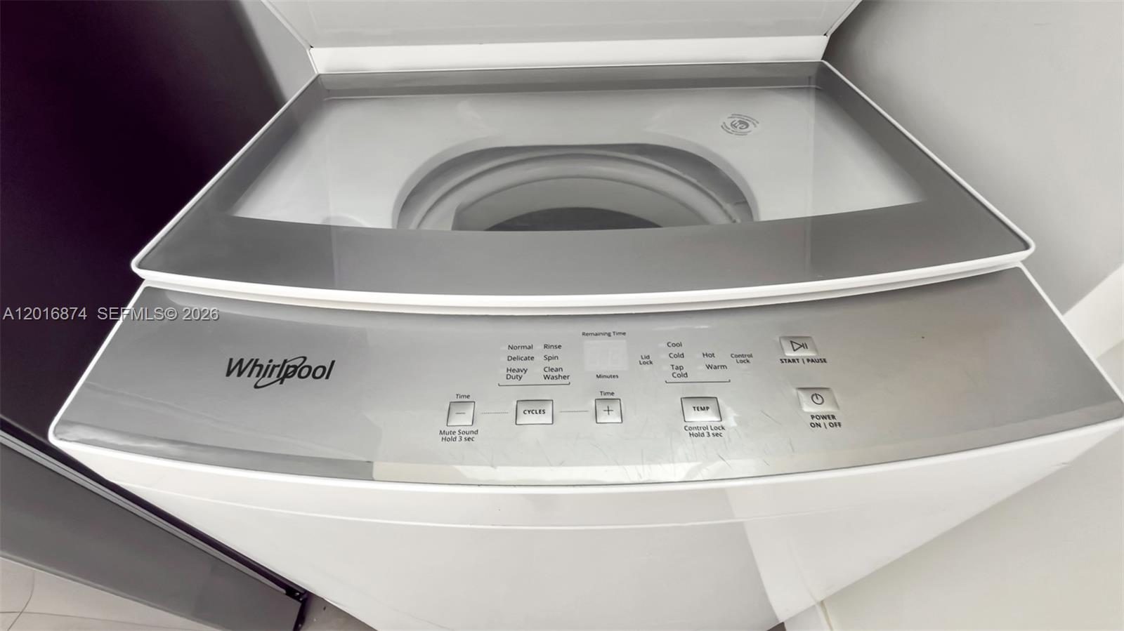A top-loading Whirlpool washing machine with a glass lid and digital control panel — 1536 NW 15th Ave # 206, Miami FL 33125, MIAMI, FL