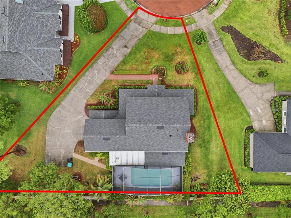 An aerial view shows a house with a pool and driveway within a triangular lot — 4498 REAL COURT, ORLANDO, FL