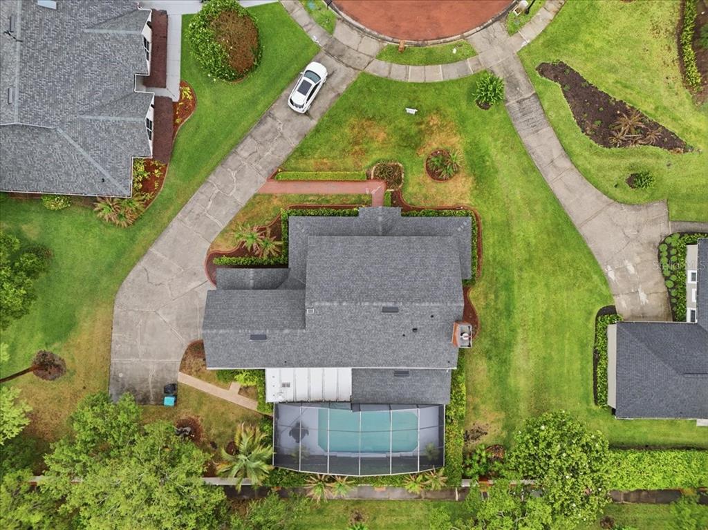 An aerial view shows a house with a screened-in pool and a long driveway — 4498 REAL COURT, ORLANDO, FL
