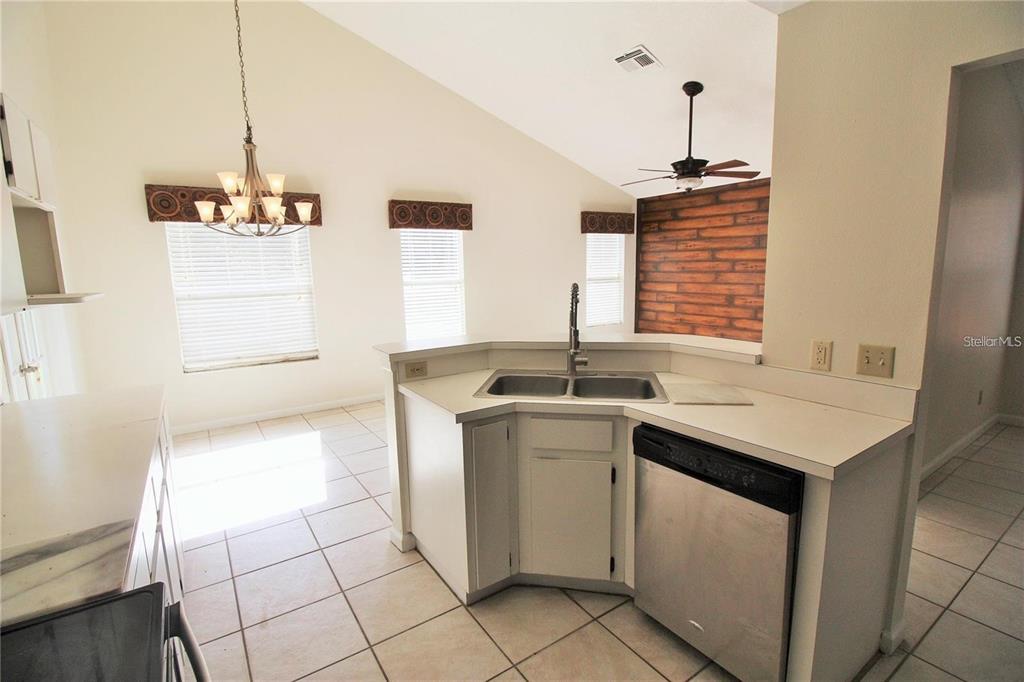 A kitchen with white cabinets, a corner sink, and a stainless steel dishwasher — 1309 BLACK WILLOW TRAIL, ALTAMONTE SPRINGS, FL