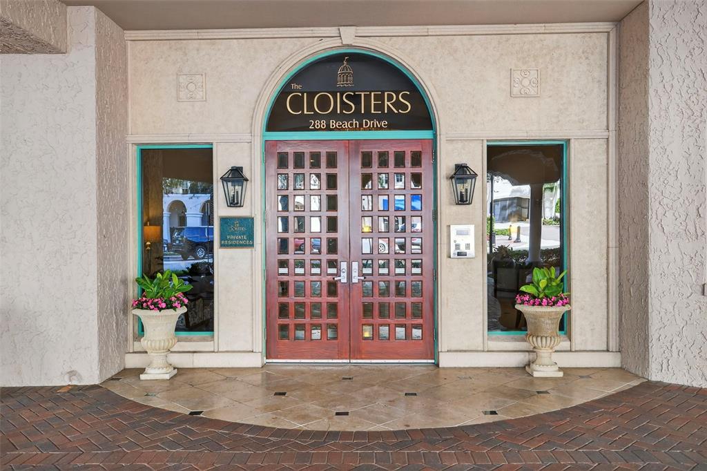 The exterior entrance of a building features double wooden doors under a decorative arched sign — 288 BEACH DRIVE NE UNIT 4B, ST PETERSBURG, FL
