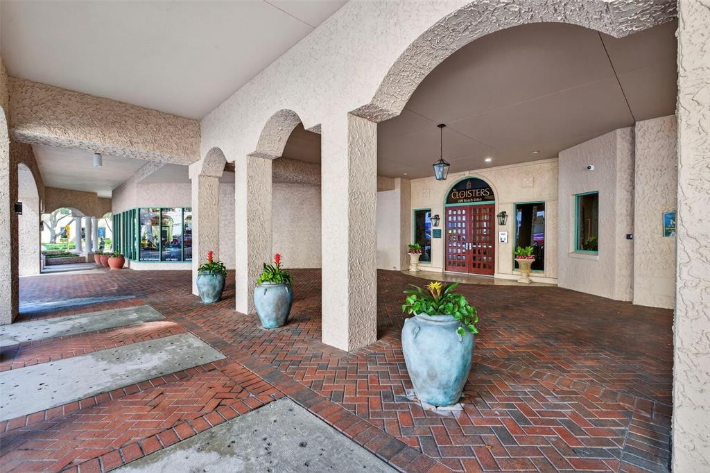 A covered brick entryway features arched columns, potted plants, and a double-door building entrance — 288 BEACH DRIVE NE UNIT 4B, ST PETERSBURG, FL