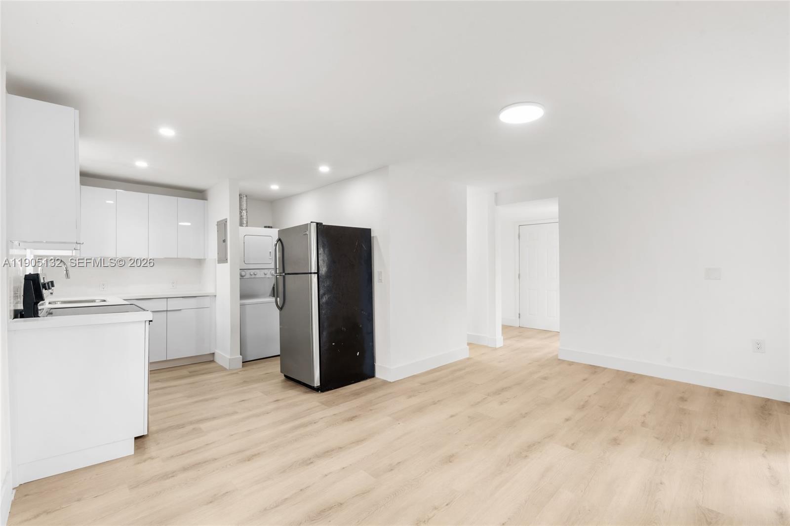 A kitchen with white cabinets, stainless steel appliances, and light wood-look flooring — 2385 SW 17th St, Miami FL 33145, MIAMI, FL