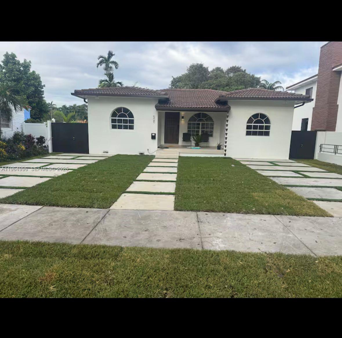 A single-story white house with a tiled roof and a paved driveway with grass strips — 508 De Leon Dr, Miami Springs FL 33166, MIAMI SPRINGS, FL