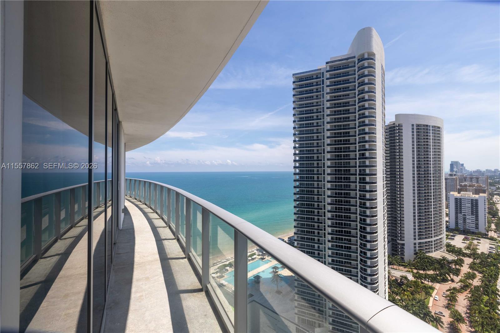 A curved balcony overlooks the ocean and neighboring high-rise residential buildings — 4111 S Ocean Dr # 2111, Hollywood FL 33019, HOLLYWOOD, FL