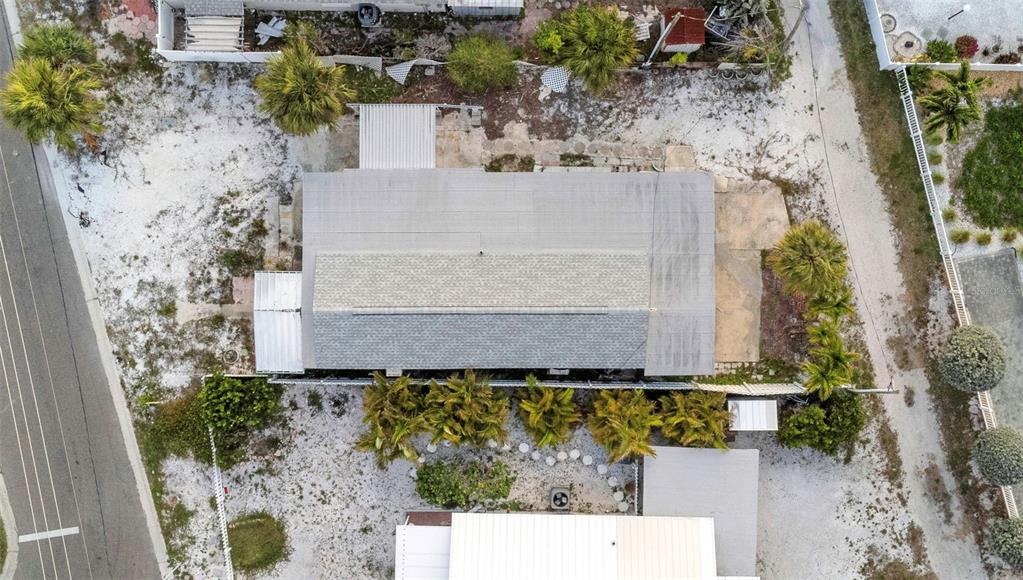 An aerial view shows a coastal town situated between the ocean and an inlet — 148 98TH AVENUE, TREASURE ISLAND, FL
