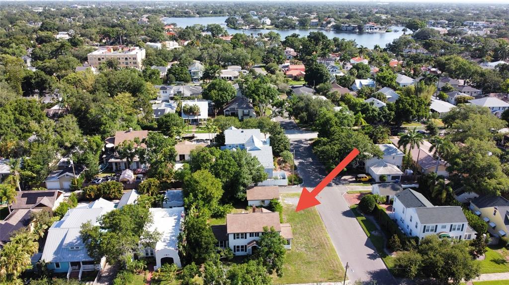 An aerial view shows a house with a large adjacent vacant lot on a street — 255 19TH AVENUE NE, ST PETERSBURG, FL
