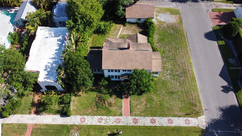 An aerial view shows a two-story house with a brown roof and a detached garage — 255 19TH AVENUE NE, ST PETERSBURG, FL