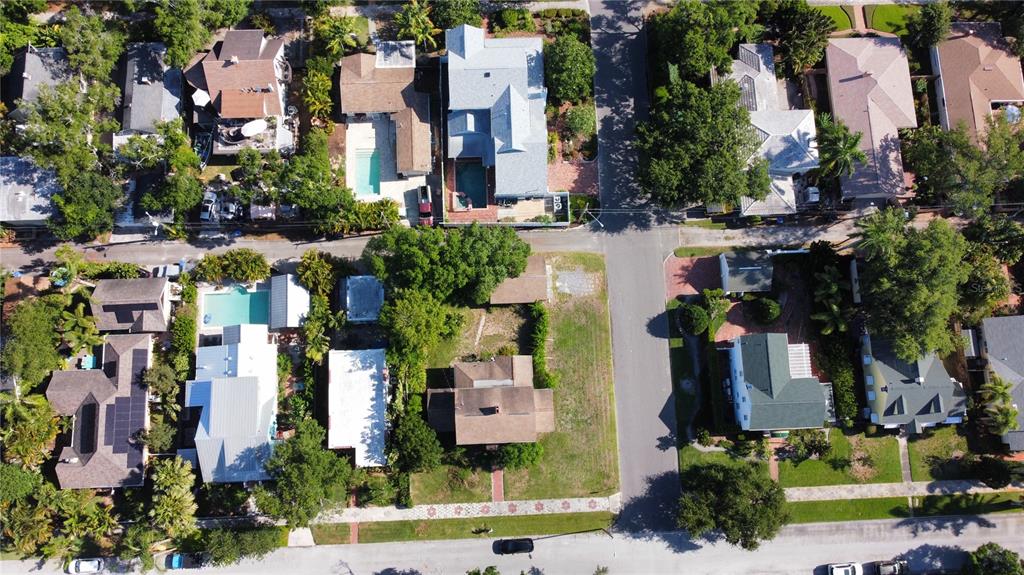 An aerial view shows a residential neighborhood with houses, swimming pools, and tree-lined streets — 255 19TH AVENUE NE, ST PETERSBURG, FL