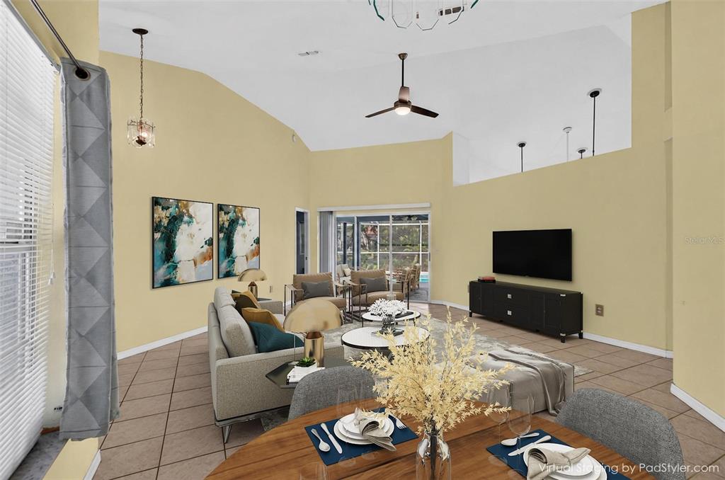 This virtual staging rendering shows a living room with high ceilings, tile floors, and furniture — 2791 GOLF LAKE DRIVE UNIT 55, PLANT CITY, FL