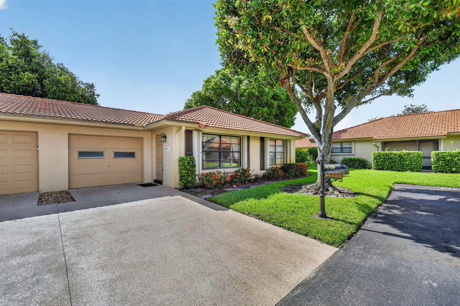 A single-story house with a tan stucco exterior, tile roof, and a concrete driveway — 9930 Frangipani Tree Way # B, Boynton Beach FL 33436, BOYNTON BEACH, FL