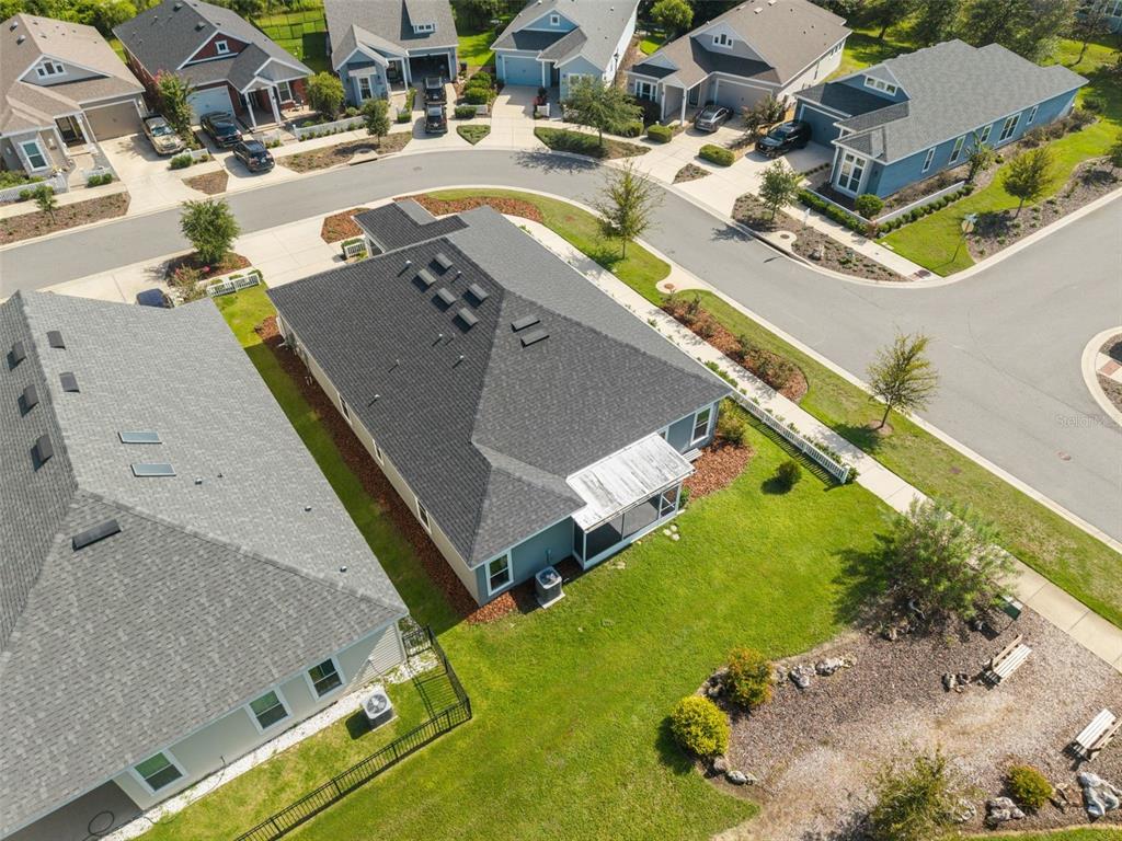 A single-story house with gray siding, stone accents, and a white picket fence — 1429 NW 132ND BOULEVARD, NEWBERRY, FL
