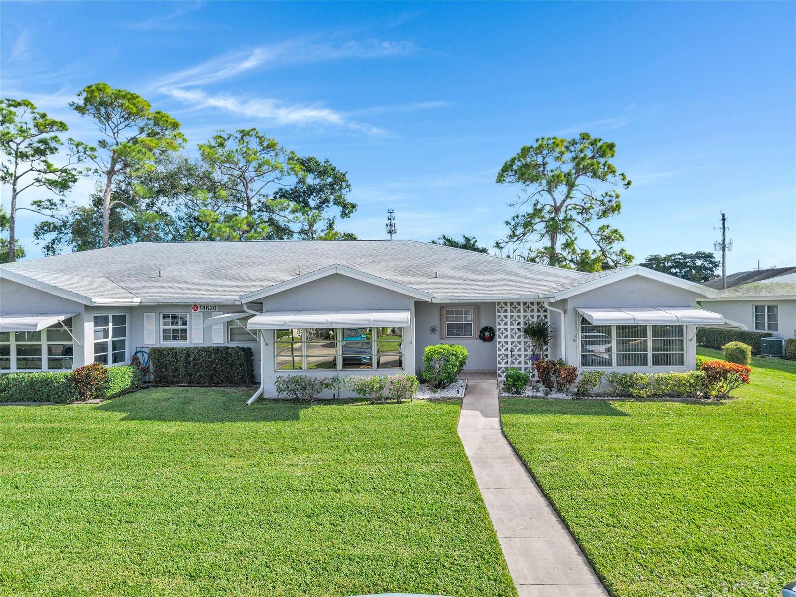 A single-story house with a gray roof, white awnings, and a concrete walkway — 14620 Canalview Drive # C, Delray Beach FL 33484, DELRAY BEACH, FL