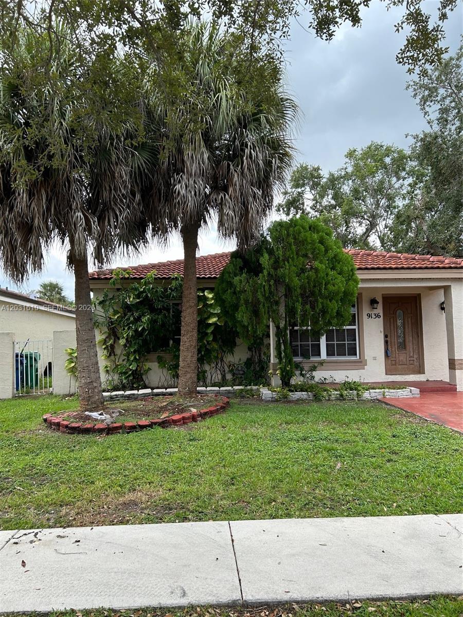 A single-story house with a tiled roof, palm trees, and a front lawn — 9136 NW 192nd Ter, Hialeah FL 33018, HIALEAH, FL