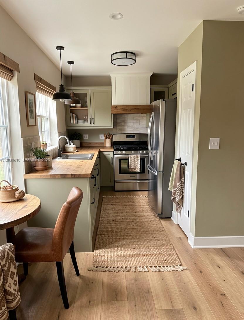 A kitchen features sage green cabinets, wood countertops, stainless steel appliances, and a jute runner — 9136 NW 192nd Ter, Hialeah FL 33018, HIALEAH, FL