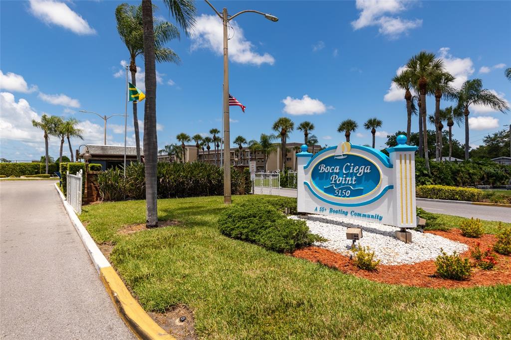 A blue and white sign marks the entrance to the Boca Ciega Point community — 1 S BOCA CIEGA POINT BOULEVARD UNIT 204, ST PETERSBURG, FL