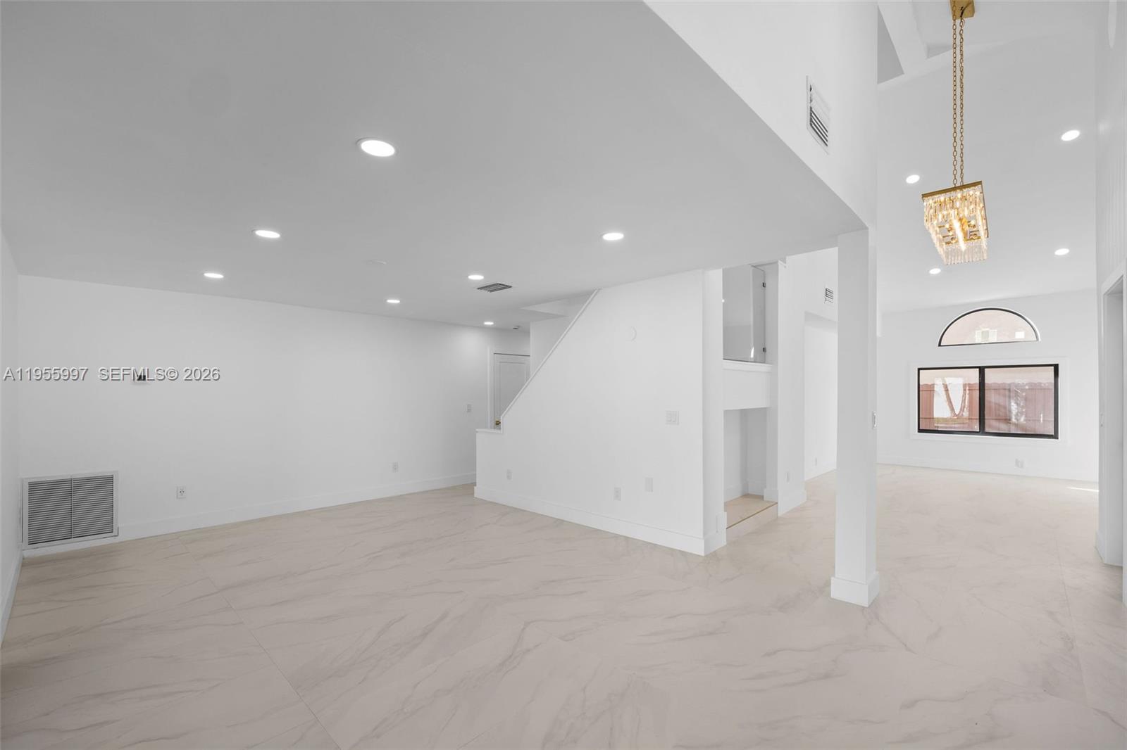 A bright, open-concept living area features white walls, recessed lighting, and light-colored tile flooring — 11260 SW 157th Ct, Miami FL 33196, MIAMI, FL