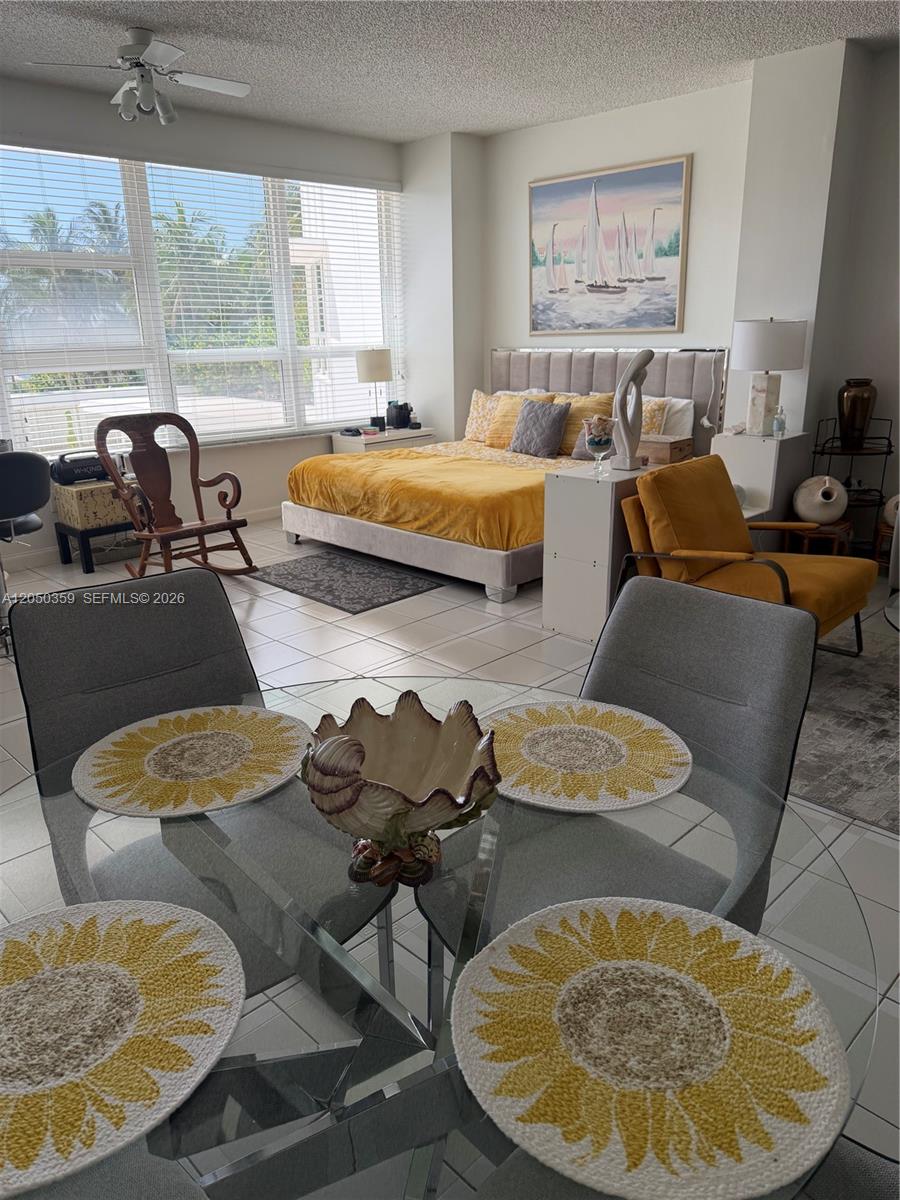 A studio apartment features a dining area with a glass table and a bedroom space — 4925 Collins Ave # 2D, Miami Beach FL 33140, MIAMI BEACH, FL
