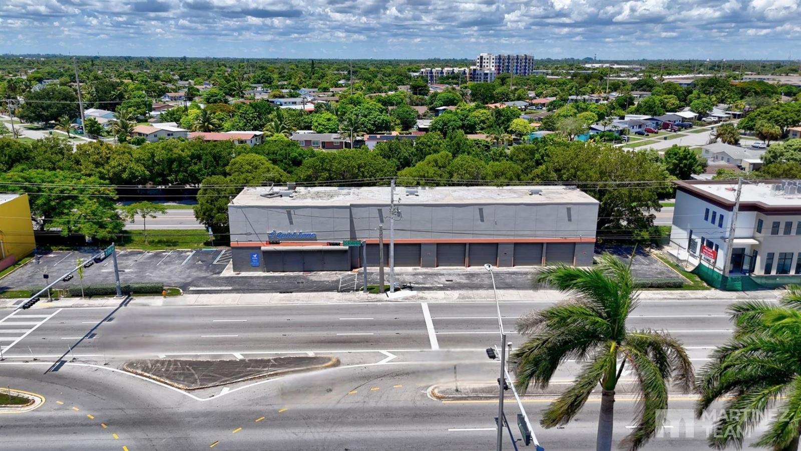 An aerial view shows a gray commercial building with multiple garage bays along a road — 20390 S Dixie Highway, Cutler Bay FL 33189, CUTLER BAY, FL