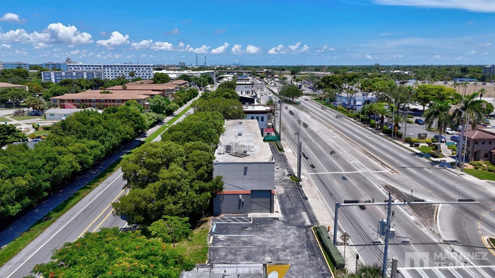 An aerial view shows a commercial building situated between a multi-lane road and trees — 20390 S Dixie Highway, Cutler Bay FL 33189, CUTLER BAY, FL