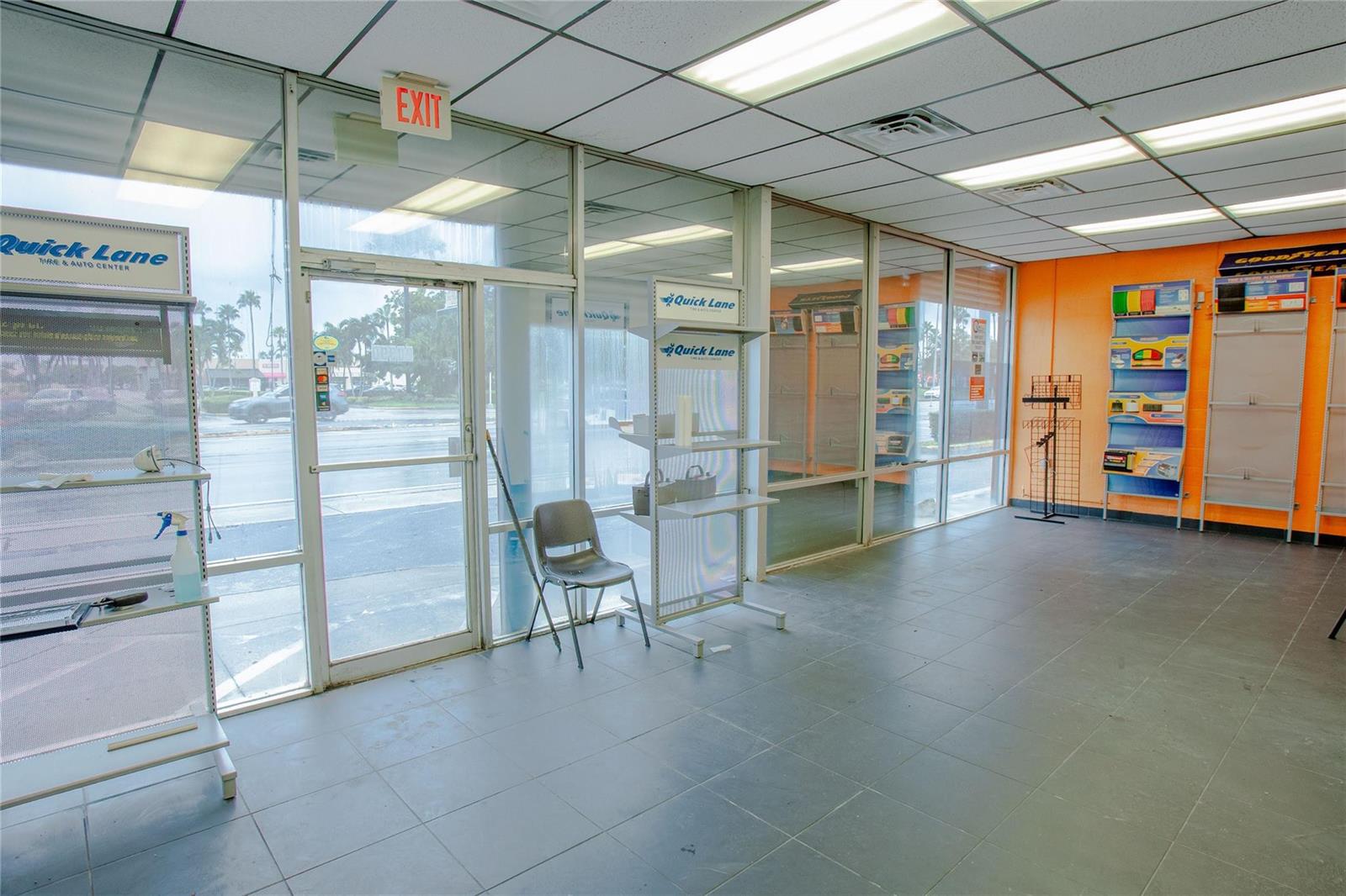 An empty commercial space features tile flooring, glass storefront windows, and orange accent walls — 20390 S Dixie Highway, Cutler Bay FL 33189, CUTLER BAY, FL