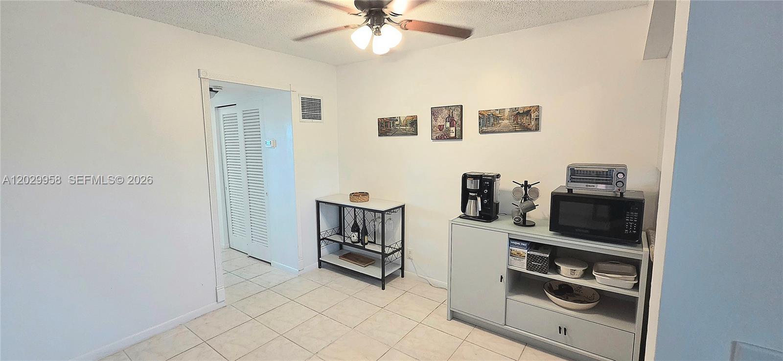 A dining area features tile flooring, a ceiling fan, a console table, and a sideboard — 2145 Pierce St # 305, Hollywood FL 33020, HOLLYWOOD, FL
