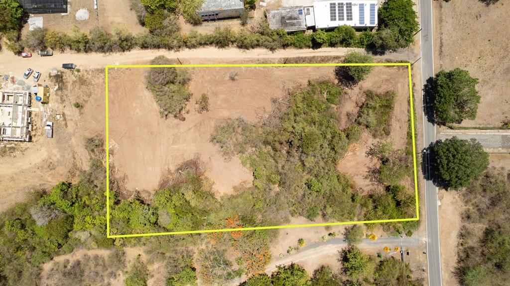 An aerial view shows a rectangular plot of land outlined in yellow next to a road — 22 CALLE DE BATU, VIEQUES, PR