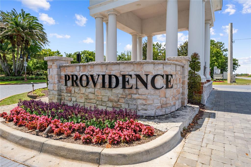 A stone monument sign reading Providence sits in front of a white columned entrance structure — 1935 GREENBRIAR TERRACE, DAVENPORT, FL
