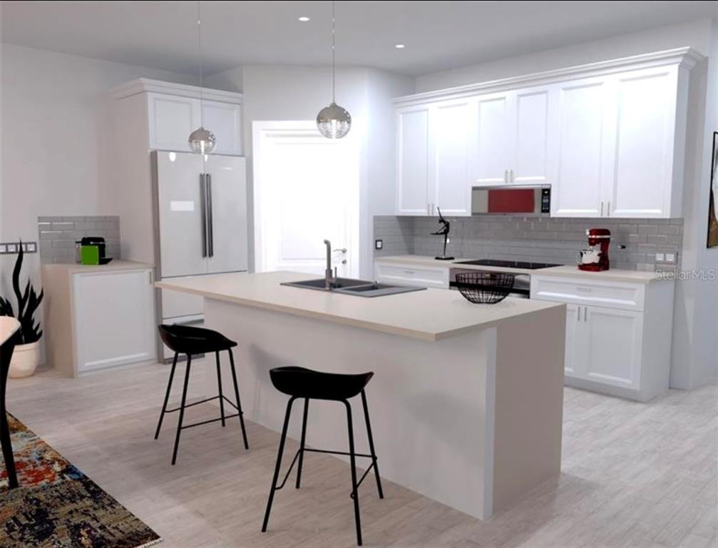A kitchen features white cabinets, granite countertops, a stainless steel refrigerator, and a center island — 2951 W YORKSHIRE PLACE, CITRUS SPRINGS, FL