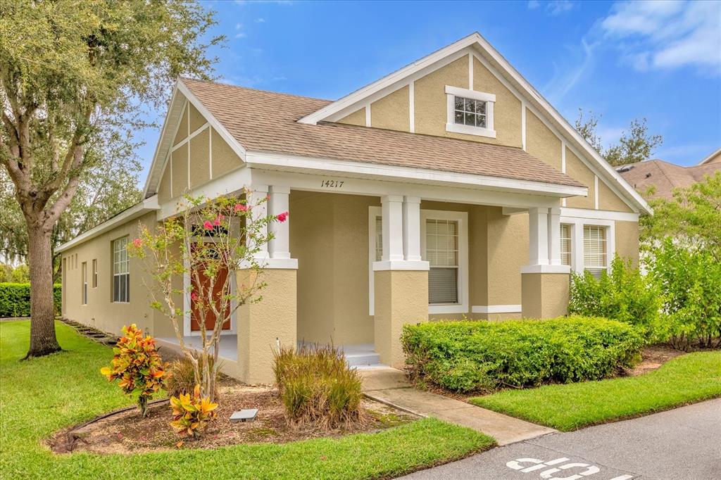 A tan, single-story house with a front porch, gabled roof, and landscaped yard — 14217  BRIDGEWATER CROSSINGS BOULEVARD, WINDERMERE, FL