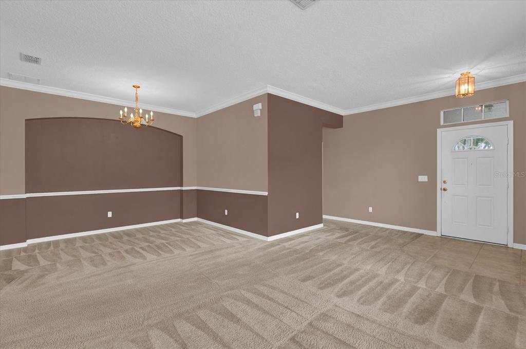 An interior view of a dining room with two-tone walls, carpeted flooring, and a chandelier — 14217  BRIDGEWATER CROSSINGS BOULEVARD, WINDERMERE, FL