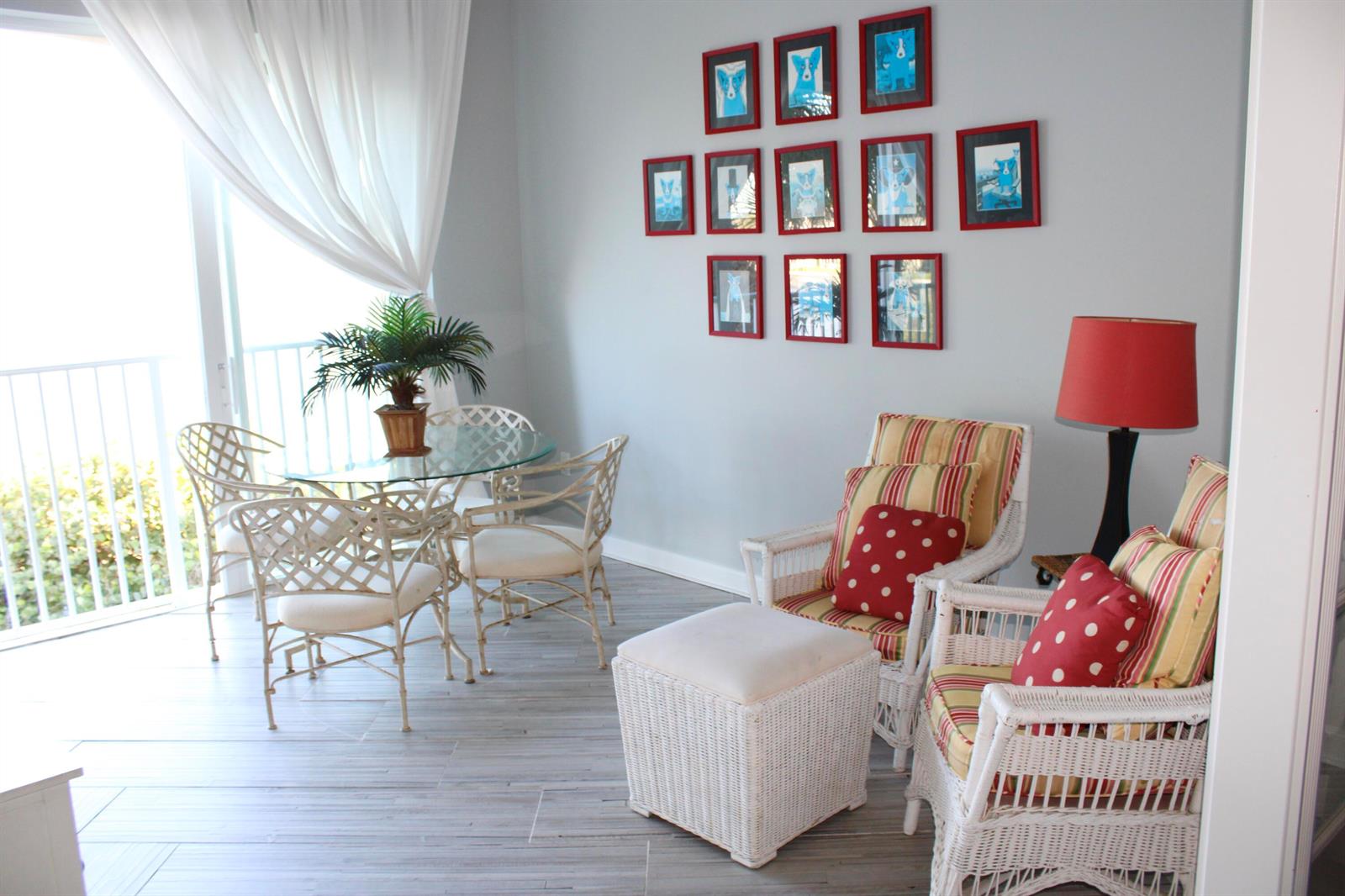 A sunlit room features a glass dining table, white wicker chairs, and two matching armchairs — 3 E Harbour Isle Drive E # 204, Fort Pierce FL 34949, FORT PIERCE, FL