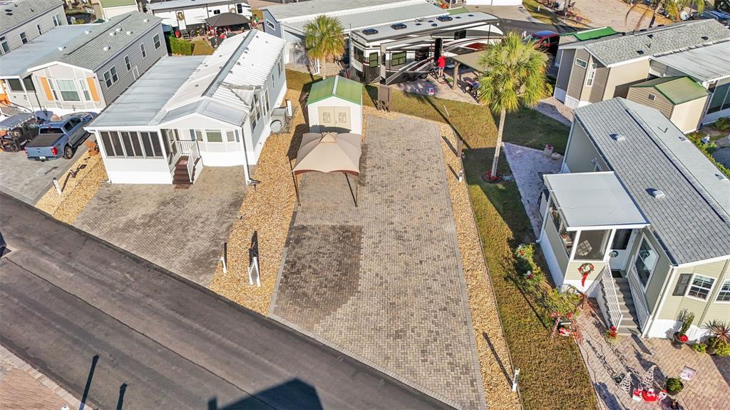 An aerial view shows two manufactured homes with paved driveways and a central storage shed — 2436 CITRUS TREE ROAD, CLERMONT, FL