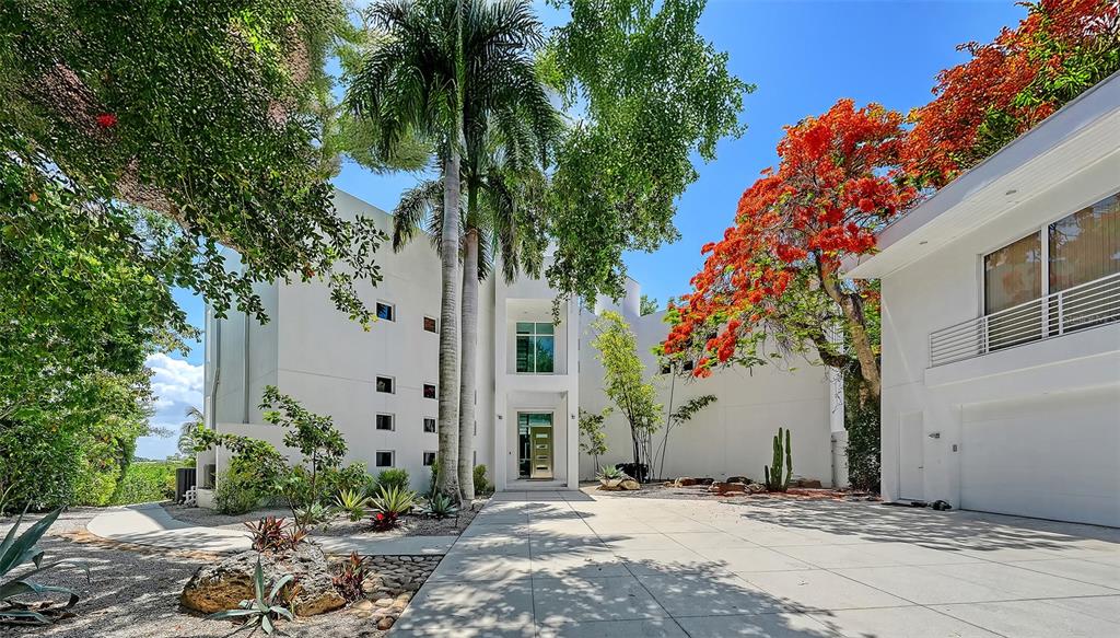 A modern white multi-story house with a curved glass facade and a backyard swimming pool — 4317 MIDNIGHT PASS ROAD, SARASOTA, FL