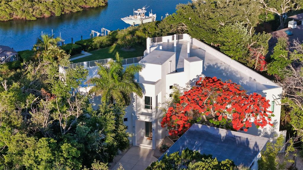 An aerial view of a modern white house with a flat roof and a flowering tree — 4317 MIDNIGHT PASS ROAD, SARASOTA, FL