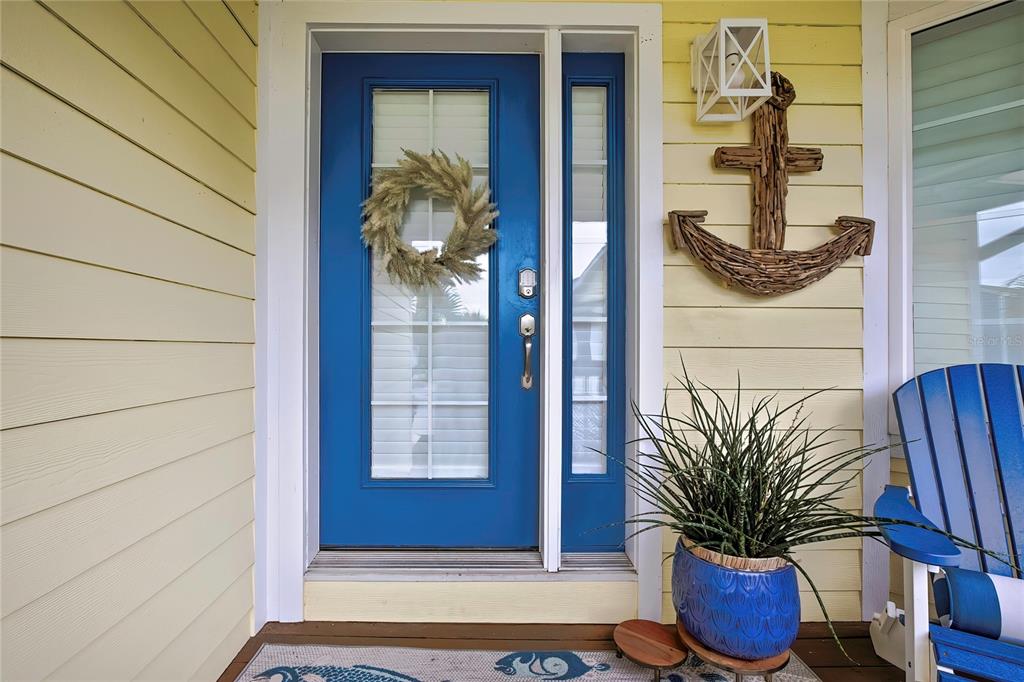 A bright blue front door with a wreath sits next to a wooden anchor decoration — 11956 W BLUE BAYOU COURT, CRYSTAL RIVER, FL
