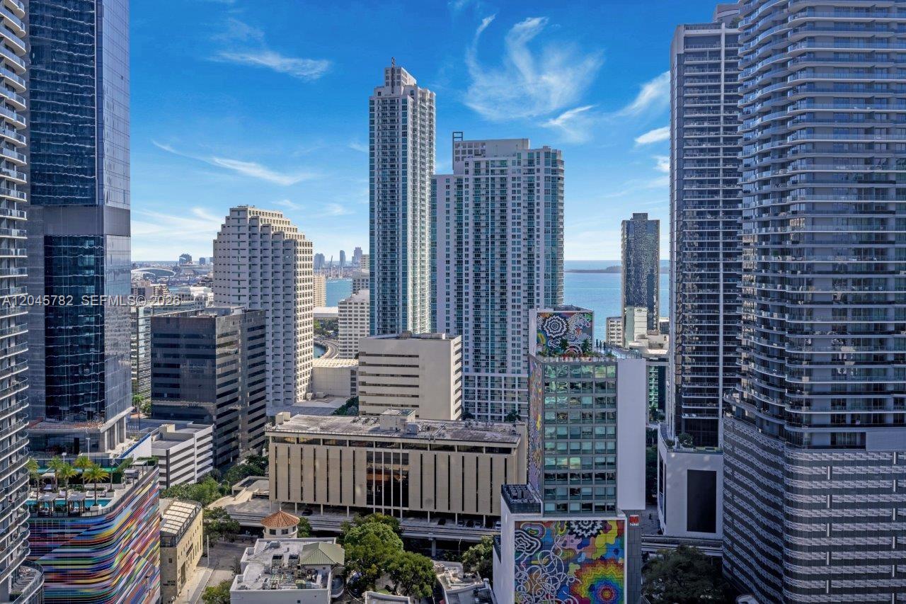 An elevated view of a dense urban skyline featuring numerous modern high-rise buildings — 999 SW 1st Ave # 2911, Miami FL 33130, MIAMI, FL