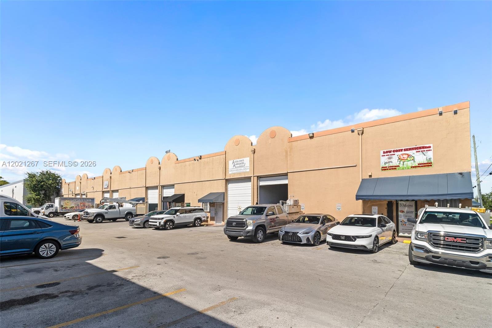 An exterior view of a commercial warehouse building with a parking lot in front — 1745 W 37th St # 5, Hialeah FL 33012, HIALEAH, FL