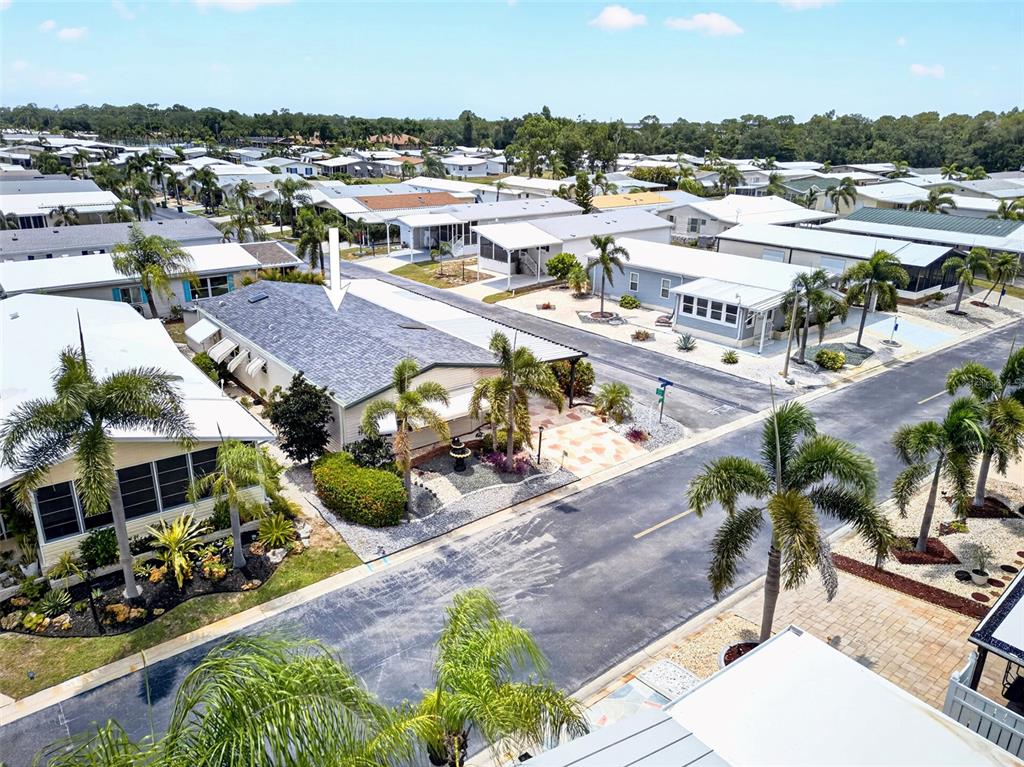 An aerial view shows a manufactured home with a gray roof in a residential community — 15550 BURNT STORE ROAD UNIT 164, PUNTA GORDA, FL