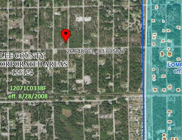 This is a satellite map showing a red location pin over a wooded residential lot — 1303 GLENN AVENUE, LEHIGH ACRES, FL
