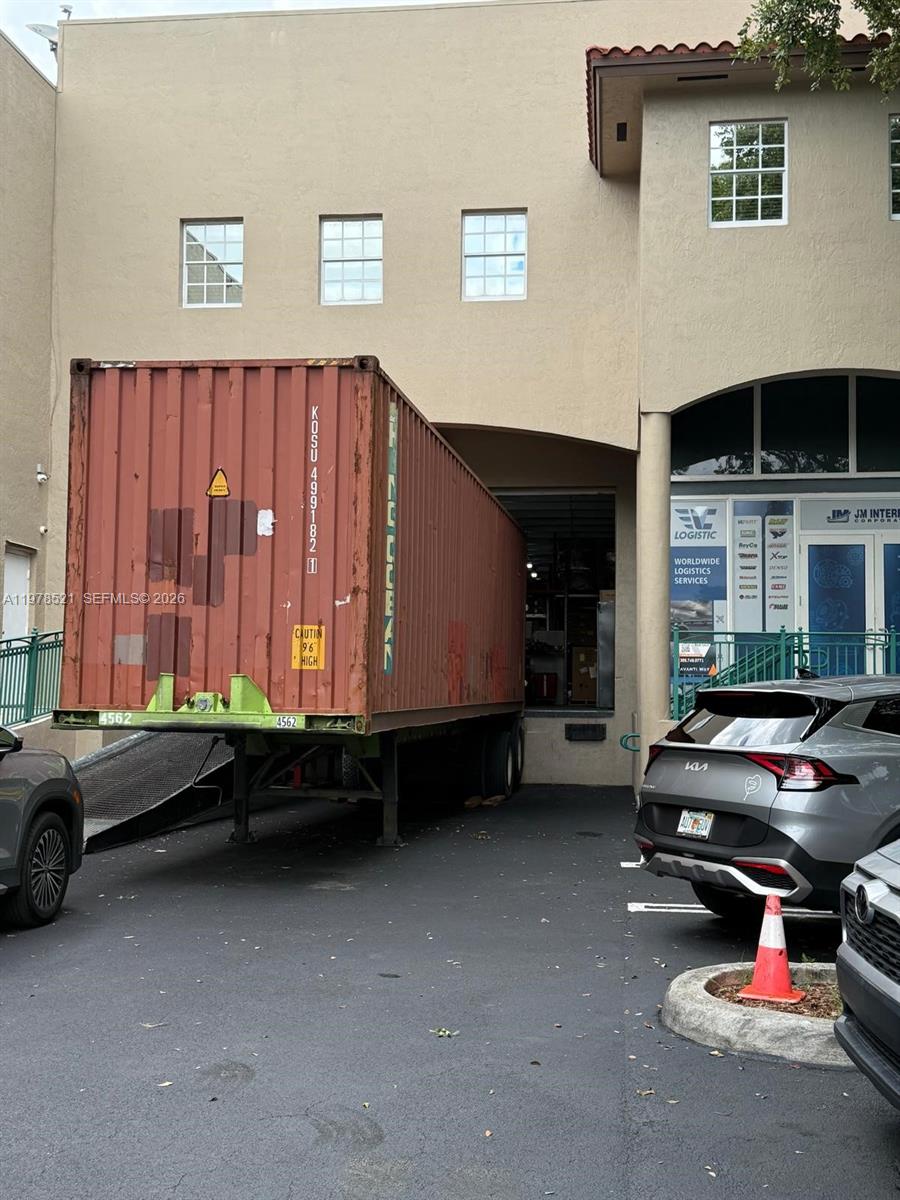A shipping container is parked at the loading dock of a commercial building — 10200 NW 25th St # 113, Doral FL 33172, DORAL, FL