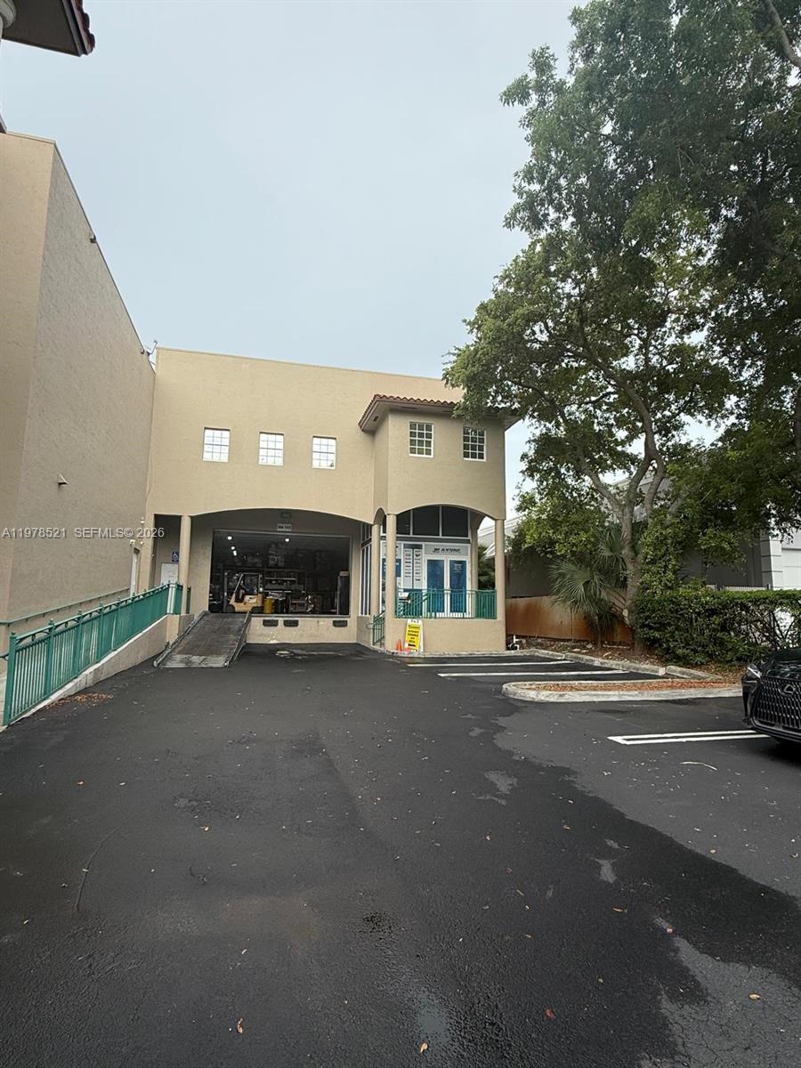 The exterior of a commercial building features a loading dock, ramp, and parking area — 10200 NW 25th St # 113, Doral FL 33172, DORAL, FL