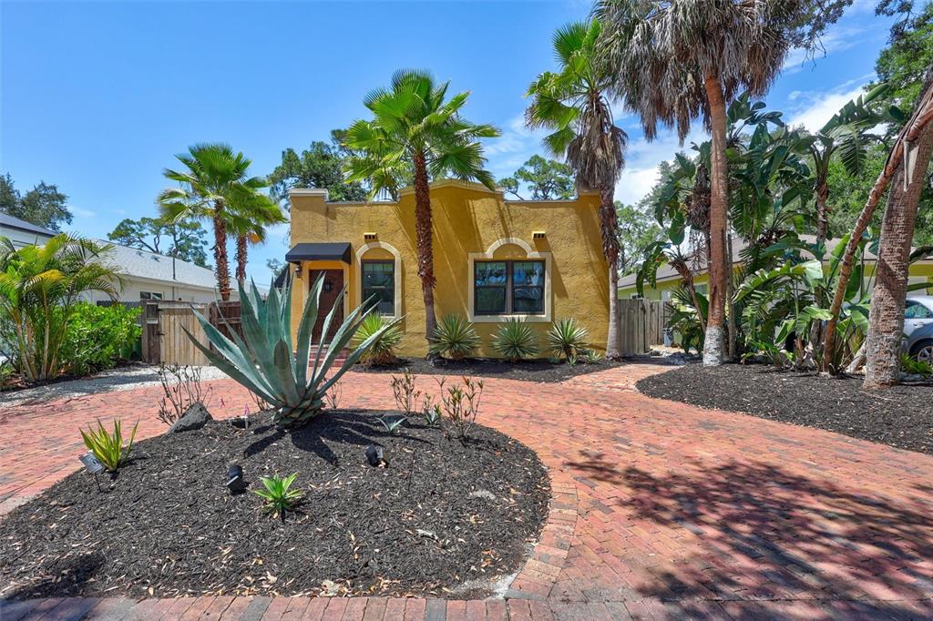 A yellow stucco house with a brick driveway and palm trees in the front yard — 2437 FLOYD STREET, SARASOTA, FL