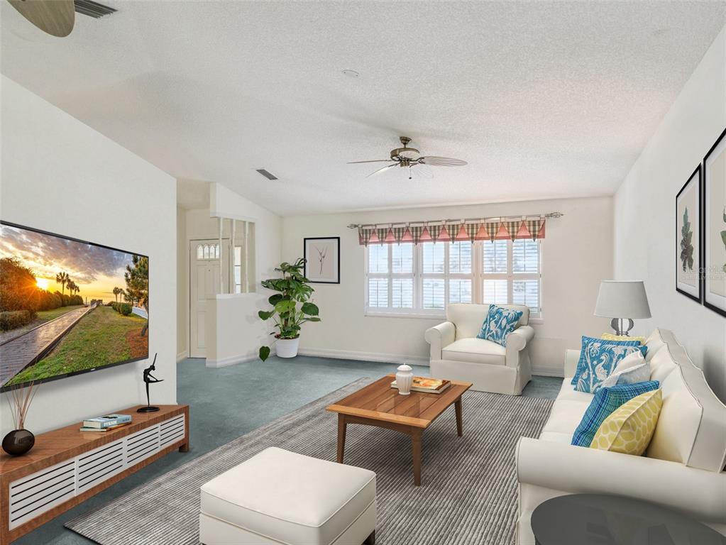 A living room features a television, a white sofa, an armchair, and a coffee table — 21230 ROYAL ST GEORGES LANE, LEESBURG, FL