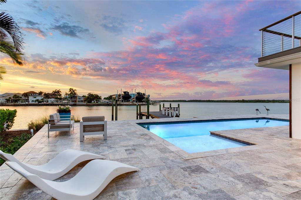 An aerial view of a waterfront house with a pool, deck, and private boat dock — 16117 4TH STREET E, REDINGTON BEACH, FL