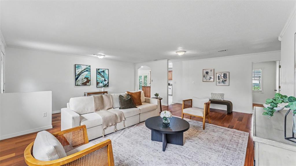 A living room features a white sofa, two wooden armchairs, and a round coffee table — 4020 GLEN GARRY ROAD W, LAKELAND, FL